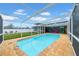 Enclosed pool with a flamingo floaty, and an outdoor living space in background at 9801 56Th N St, Pinellas Park, FL 33782