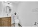 Stylish powder room with a modern vanity, decorative flooring and bright white walls at 9801 56Th N St, Pinellas Park, FL 33782