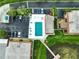 Overhead view of the property featuring ample parking, an inground pool, and waterfront access at 10196 Seminole Island Dr, Largo, FL 33773