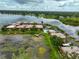 Aerial view of waterfront condos featuring water access, community pool, and ample parking at 10196 Seminole Island Dr, Largo, FL 33773