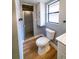 Bathroom with gray walls, wood-look flooring, and shower with glass door at 10196 Seminole Island Dr, Largo, FL 33773