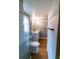 View of the bathroom with wood-look flooring, toilet, and vanity at 10196 Seminole Island Dr, Largo, FL 33773