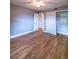 Bedroom featuring wood-look floors, white trim, and a ceiling fan at 10196 Seminole Island Dr, Largo, FL 33773