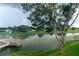 Scenic view of the lake, featuring a dock and mature trees at 10196 Seminole Island Dr, Largo, FL 33773
