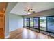 Well-lit sunroom with stunning lake views and modern ceiling fan at 10196 Seminole Island Dr, Largo, FL 33773