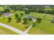 An aerial view of a well-manicured property showcases a home with lush greenery, mature trees, and a private driveway at 10510 Lithia Estates Dr, Lithia, FL 33547