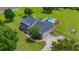 Aerial shot of home with beautiful landscaping, backyard pool, and a long driveway at 10510 Lithia Estates Dr, Lithia, FL 33547