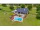 Aerial view of a beautiful home featuring a pool, lush landscaping, and private backyard at 10510 Lithia Estates Dr, Lithia, FL 33547