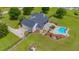 An aerial view of a beautifully landscaped home with a backyard pool and screened-in patio at 10510 Lithia Estates Dr, Lithia, FL 33547