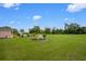 Backyard boasts a sprawling green lawn and equipment to service the pool at 10510 Lithia Estates Dr, Lithia, FL 33547