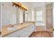 Bathroom features dual sinks, a large mirror, and a soaking tub at 10510 Lithia Estates Dr, Lithia, FL 33547
