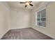 Bedroom features a carpeted floor, ceiling fan, and a large window at 10510 Lithia Estates Dr, Lithia, FL 33547