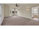 Spacious bedroom with carpeting, ceiling fan, and adjoining bathroom at 10510 Lithia Estates Dr, Lithia, FL 33547