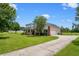 Lovely home with a long driveway, a manicured lawn and mature trees at 10510 Lithia Estates Dr, Lithia, FL 33547