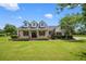 Charming home with a large front porch, dormer windows, and a well-manicured lawn at 10510 Lithia Estates Dr, Lithia, FL 33547