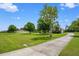 Beautiful home with a long driveway, expansive front yard, and mature trees for added privacy at 10510 Lithia Estates Dr, Lithia, FL 33547