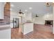 Open concept kitchen with breakfast bar, white cabinets, and stainless steel appliances at 10510 Lithia Estates Dr, Lithia, FL 33547