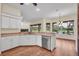 Bright kitchen features stainless steel appliances, wood floors, and a view to the outside at 10510 Lithia Estates Dr, Lithia, FL 33547