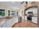Bright kitchen features stainless steel appliances, wood floors, and a brick arch over the range at 10510 Lithia Estates Dr, Lithia, FL 33547