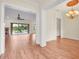 Bright living room with hardwood floors, a ceiling fan, and access to a screened-in outdoor space at 10510 Lithia Estates Dr, Lithia, FL 33547