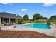 Enjoy a refreshing dip in this inviting backyard pool with brick-paver patio and lush surroundings at 10510 Lithia Estates Dr, Lithia, FL 33547