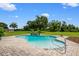 A refreshing backyard pool with a brick surround and meticulously maintained landscaping offers a serene outdoor escape at 10510 Lithia Estates Dr, Lithia, FL 33547