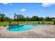 A refreshing backyard pool with a brick surround and meticulously maintained landscaping offers a serene outdoor escape at 10510 Lithia Estates Dr, Lithia, FL 33547