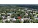 An aerial view displays a home within a neighborhood featuring abundant trees at 1116 W Kirby St, Tampa, FL 33604