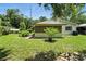 Spacious backyard features a lattice covered patio, mature trees and lush green lawn at 1116 W Kirby St, Tampa, FL 33604