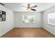 Bright bedroom with wood-look flooring, ceiling fan, and a large window offering plenty of light at 1116 W Kirby St, Tampa, FL 33604