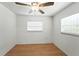Clean bedroom with wood-look flooring, a ceiling fan, and a large window for natural light at 1116 W Kirby St, Tampa, FL 33604