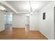 The dining room has hardwood flooring and a modern light fixture with a motivational wall sign at 1116 W Kirby St, Tampa, FL 33604