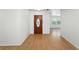 Bright foyer with wood-look flooring, decorative front door and view into the sun-drenched living area at 1116 W Kirby St, Tampa, FL 33604