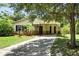 Charming single-story home featuring a covered entryway, mature landscaping, and a well-maintained front yard at 1116 W Kirby St, Tampa, FL 33604