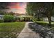 Charming single-story home with mature landscaping and a covered carport in a twilight setting at 1116 W Kirby St, Tampa, FL 33604