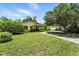 Well-maintained lawn with a covered front entrance and mature trees enhancing the curb appeal of this lovely property at 1116 W Kirby St, Tampa, FL 33604