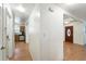 Hallway that leads to a kitchen and front entrance with views of the light, wood-look flooring at 1116 W Kirby St, Tampa, FL 33604