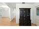 View of the hallway with hardwood flooring, vintage cabinets, and view to the dining room at 1116 W Kirby St, Tampa, FL 33604