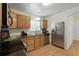 The kitchen features wooden cabinetry, stainless steel appliances, granite counters, and a stainless steel refrigerator at 1116 W Kirby St, Tampa, FL 33604