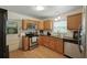 Featuring wooden cabinetry, stainless steel appliances, granite counters and a stainless steel sink at 1116 W Kirby St, Tampa, FL 33604
