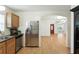 View of the kitchen leading to the front door and stainless steel refrigerator at 1116 W Kirby St, Tampa, FL 33604