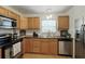 Bright kitchen featuring wood cabinets, modern appliances, and a stainless steel sink at 1116 W Kirby St, Tampa, FL 33604