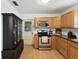 Kitchen featuring wooden cabinetry, stainless steel appliances, granite counters and outdoor access at 1116 W Kirby St, Tampa, FL 33604