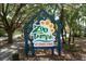A sign reads 'Zoo Tampa at Lowry Park' beneath trees, offering nearby recreation at 1116 W Kirby St, Tampa, FL 33604