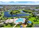 Community aerial view featuring a resort-style pool, playground, lakes, and manicured landscaping, offering a vibrant lifestyle at 11309 Langworth Hill Ln, Riverview, FL 33579