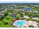 This community aerial includes a pool, playground, tennis courts, lakes, and residential homes at 11309 Langworth Hill Ln, Riverview, FL 33579