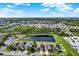 Breathtaking aerial community view of homes, a green belt, and a serene lake with surrounding trees at 11309 Langworth Hill Ln, Riverview, FL 33579