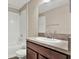 Clean bathroom with a shower-tub combo, toilet, and wood vanity with a sink at 11309 Langworth Hill Ln, Riverview, FL 33579