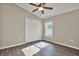 Neutral bedroom with a window and a closet, complemented by wood floors at 11309 Langworth Hill Ln, Riverview, FL 33579