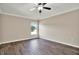 Neutral bedroom featuring hard wood floors, a ceiling fan and a window at 11309 Langworth Hill Ln, Riverview, FL 33579